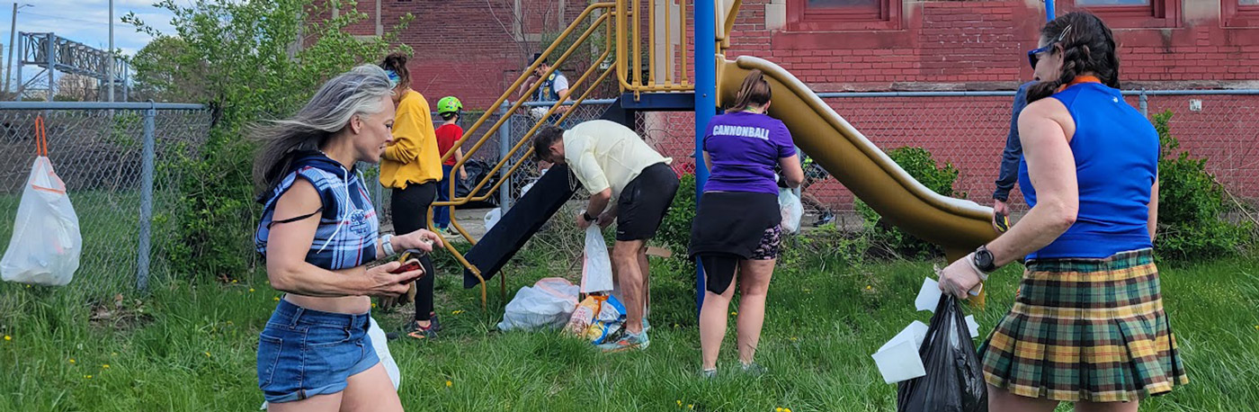 Photo of members of a Detroit area social running club cleaning up a park