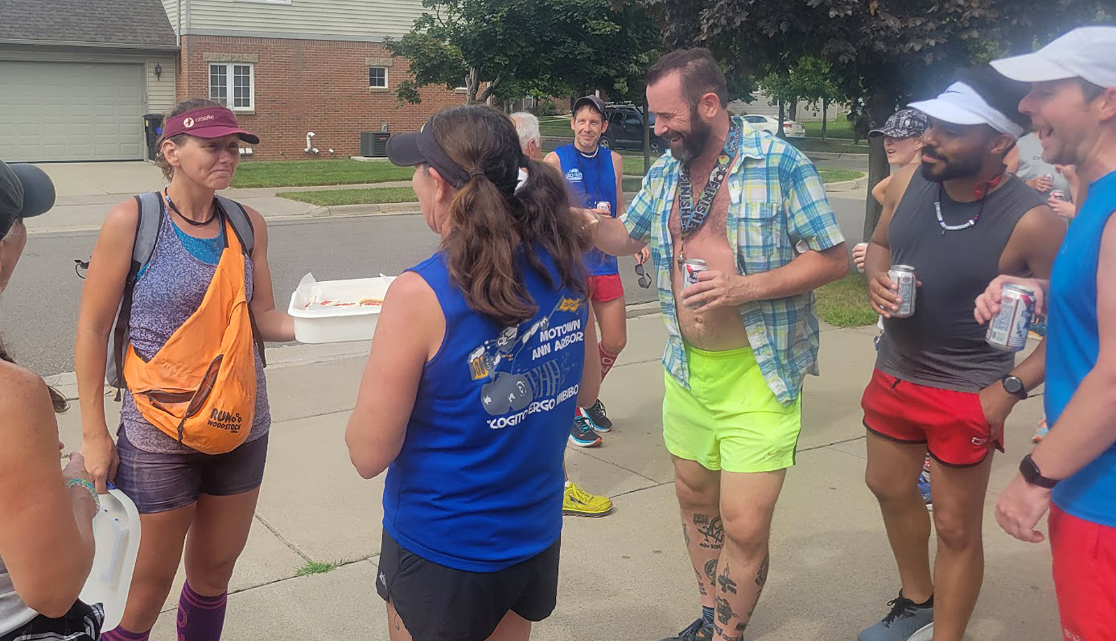 Photo of members of a Detroit area social running club during a break in the action