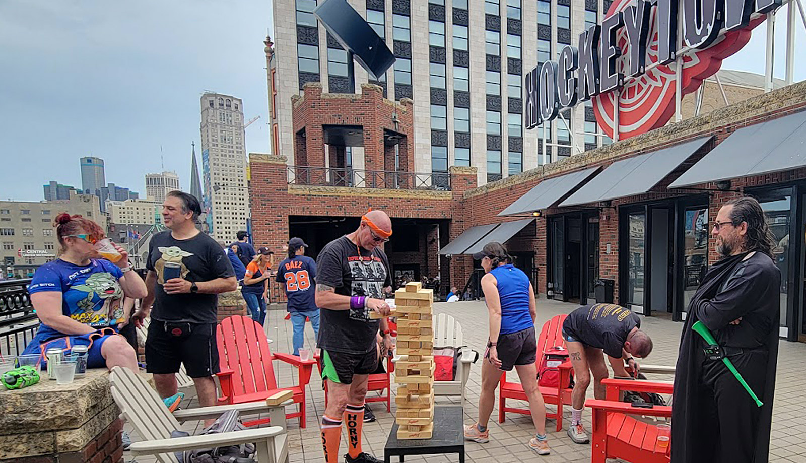 Photo of members of a Detroit area social running club gathered mid-run at a rooftop bar