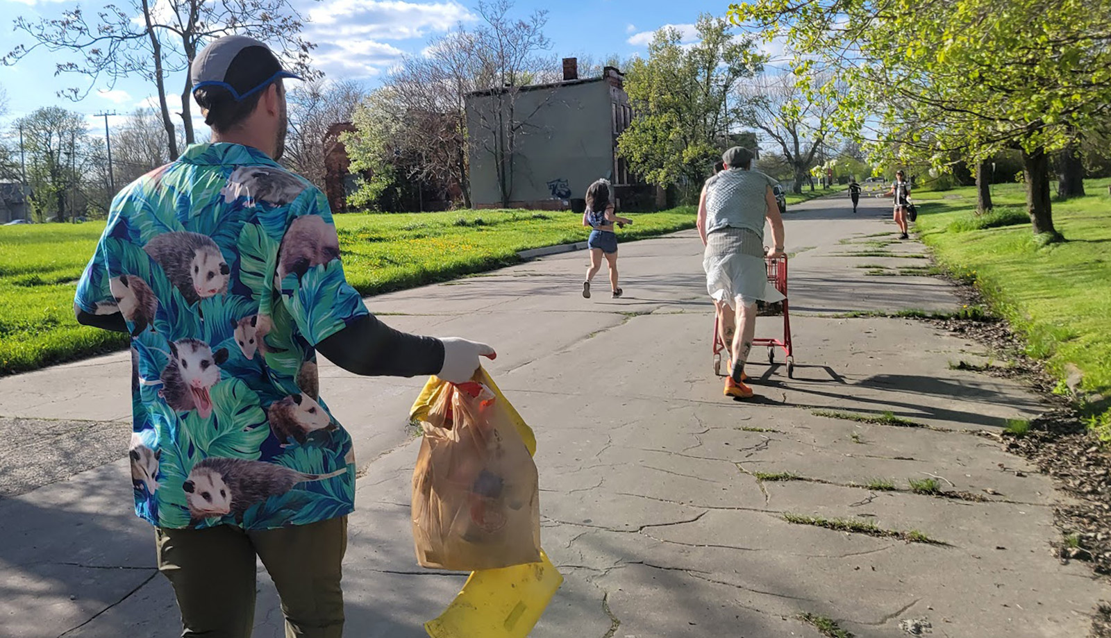 Photo of members of a Detroit area social running club cleaning up the streets